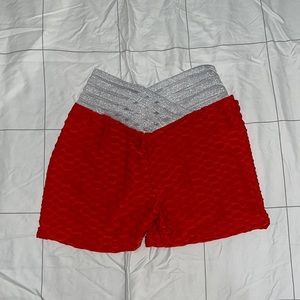 Red crossover, butt cinched, athletic shorts